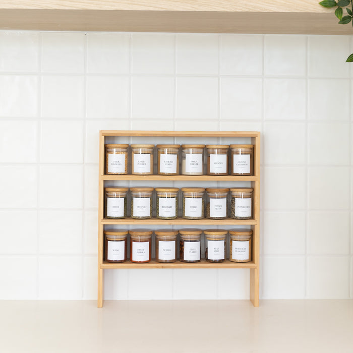 Wooden shelf with jars of various items on a white wall