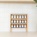 Wooden shelf with jars of various items on a white wall